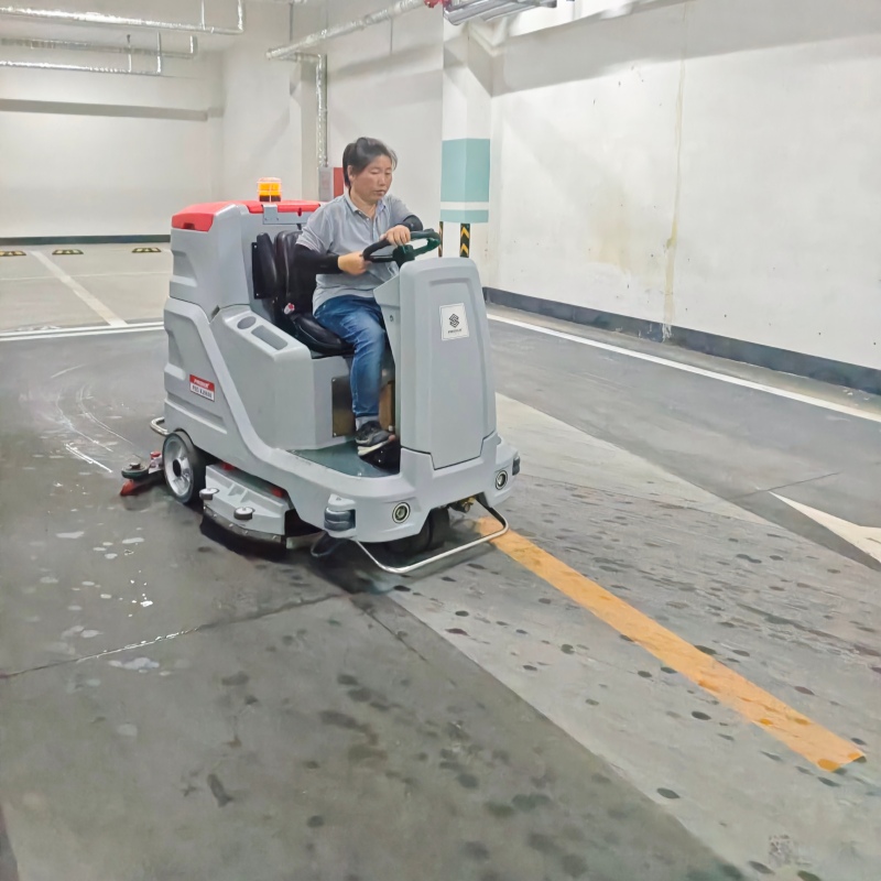 Ride-on electric floor scrubber dryer for parking lots